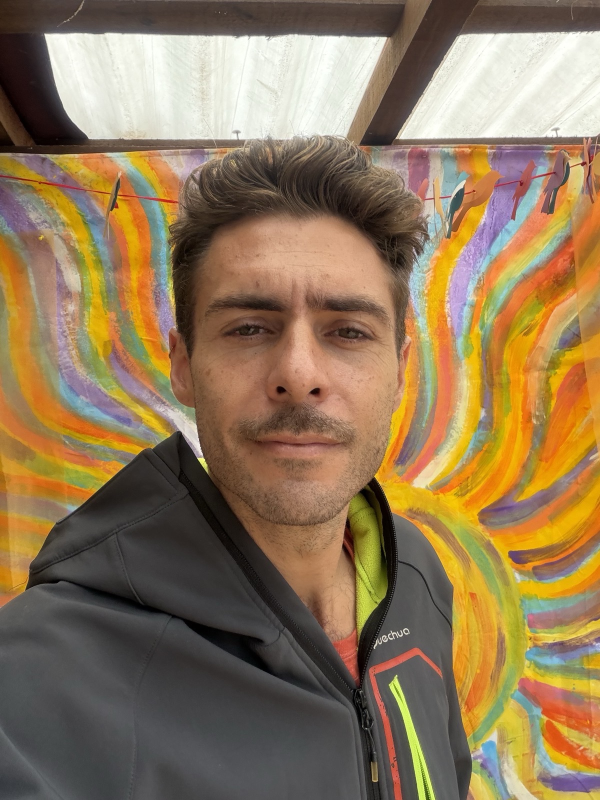 jordi amat, in front of a hand-painted flame mural